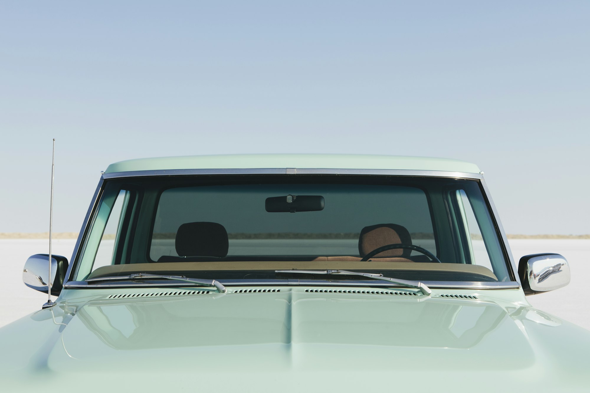 Detail of a vintage Ford F100 pickup truck, the windshield and hood. Bonneville Salt Flats.